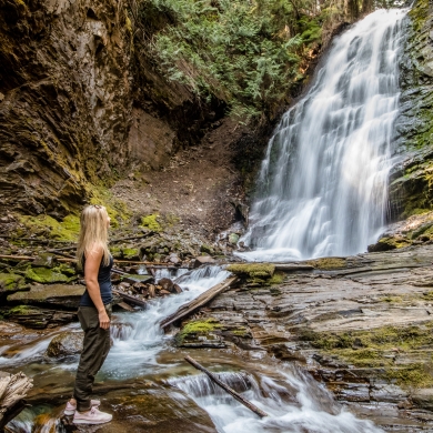 Person viewing beautiful waterfall near Kaslo, BC.